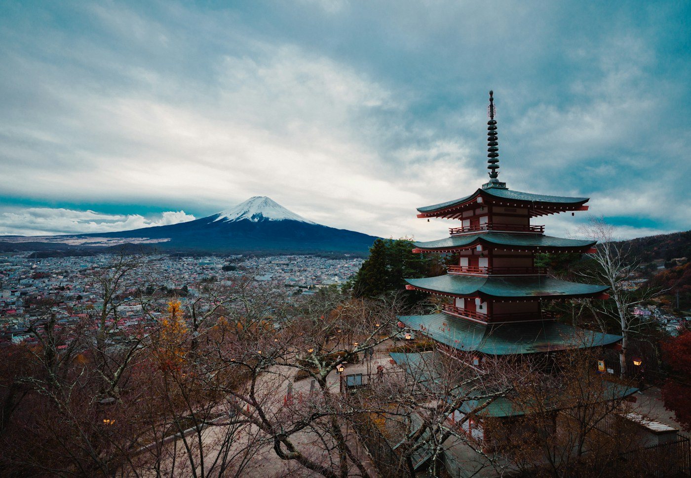 A Japanese pagoda and mountain landscape at sunset